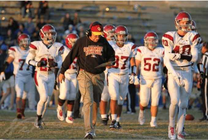 Coach Jerry Campbell walking the sideline with his team during a game